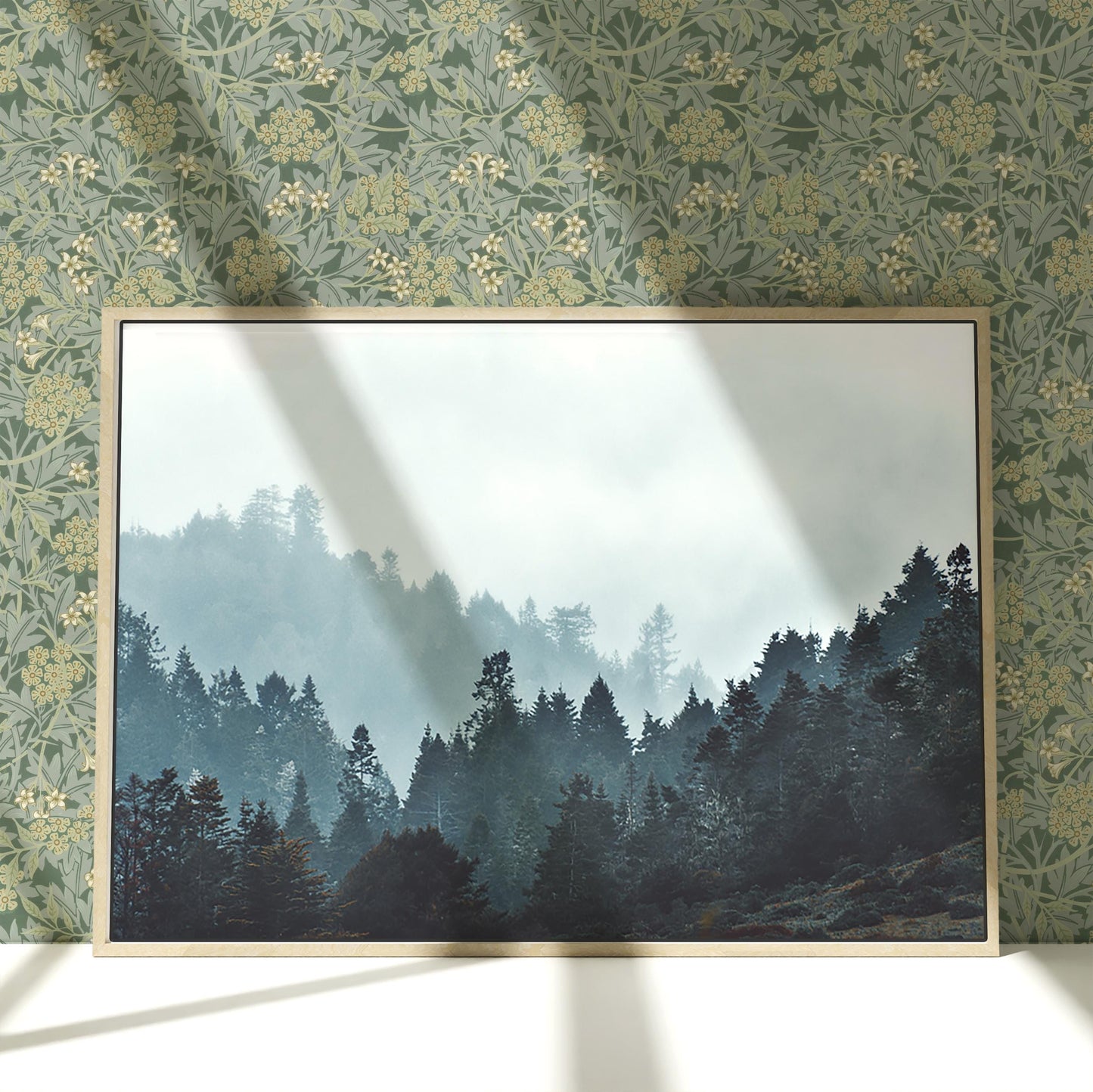 a picture of a forest in a frame on a wall