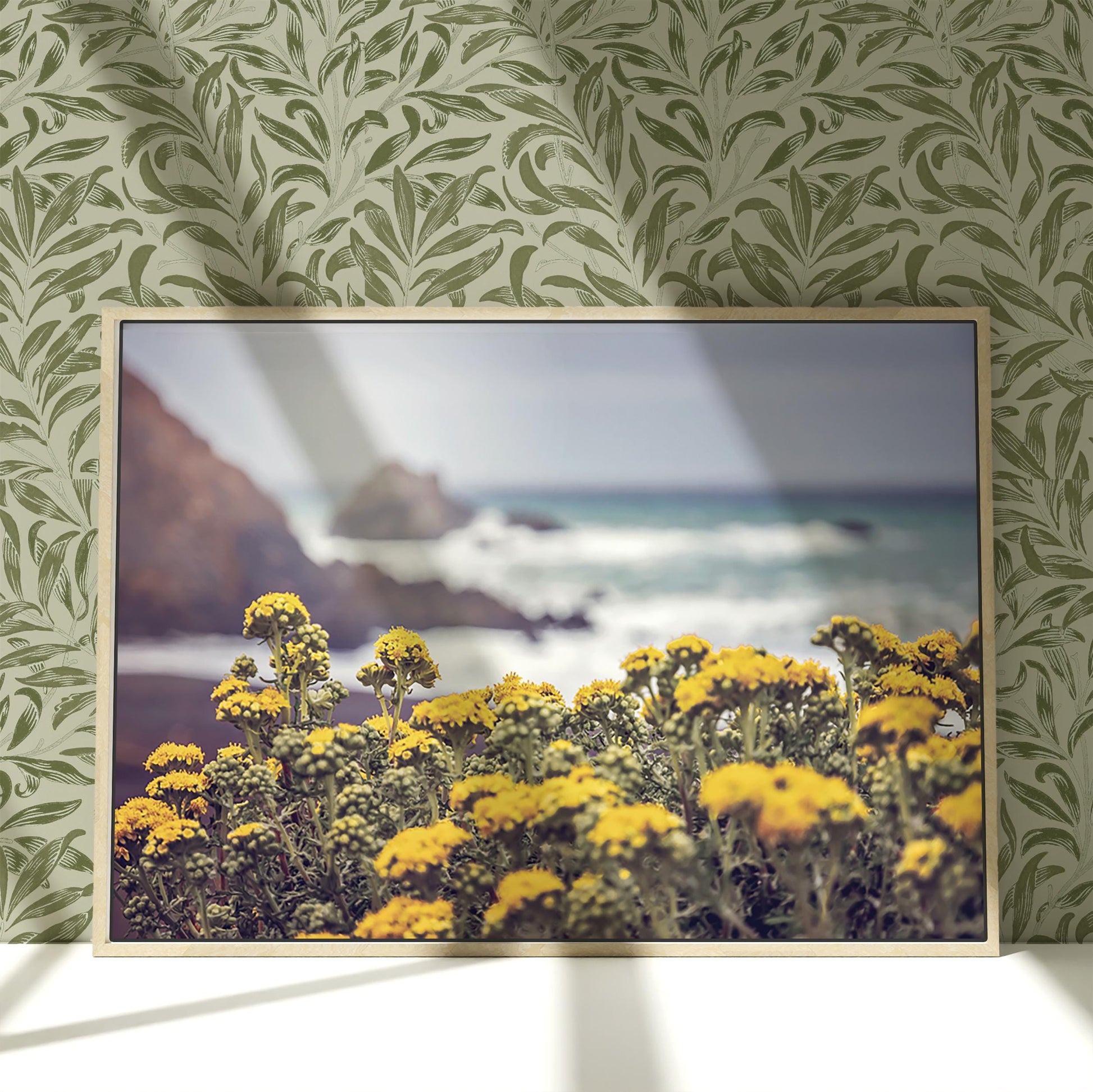 a picture of yellow flowers in front of a green wall