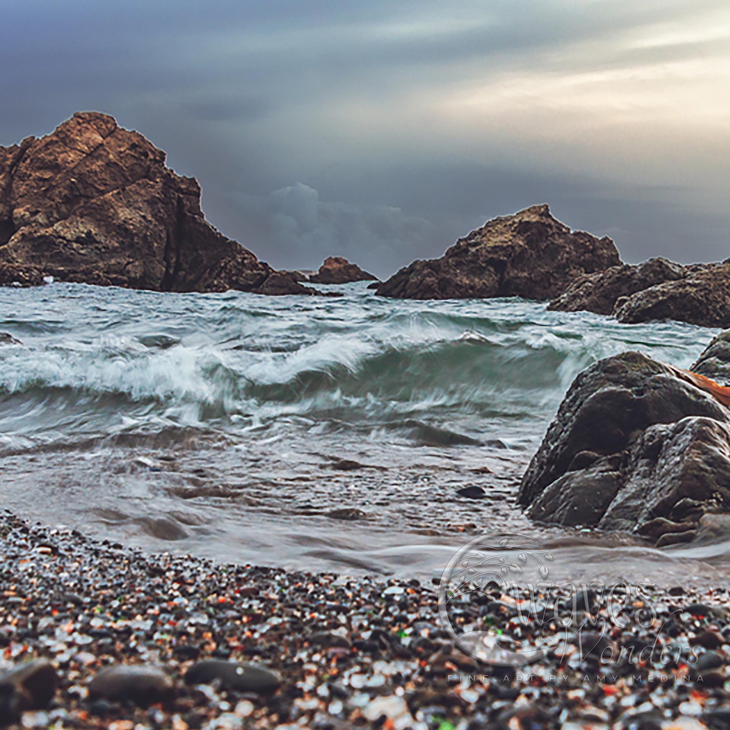 a person sitting on a rock near the ocean