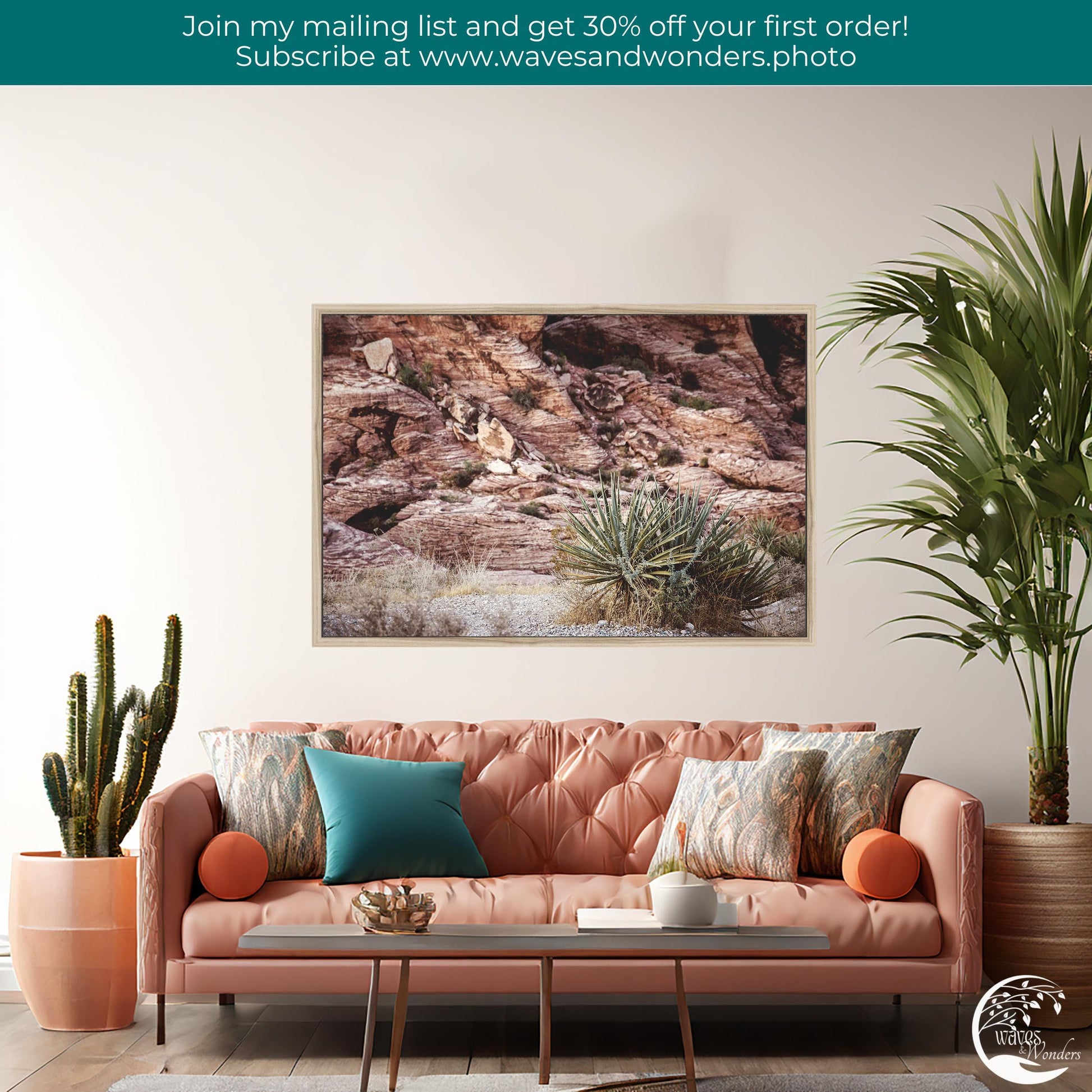 a living room with a pink couch and a painting on the wall