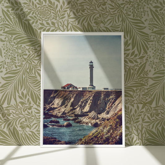 a picture of a lighthouse on a cliff by the ocean