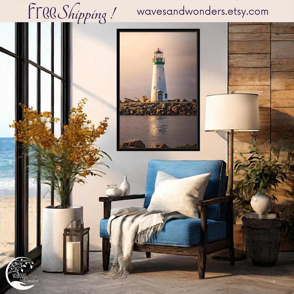 a living room with a blue chair and a picture of a lighthouse