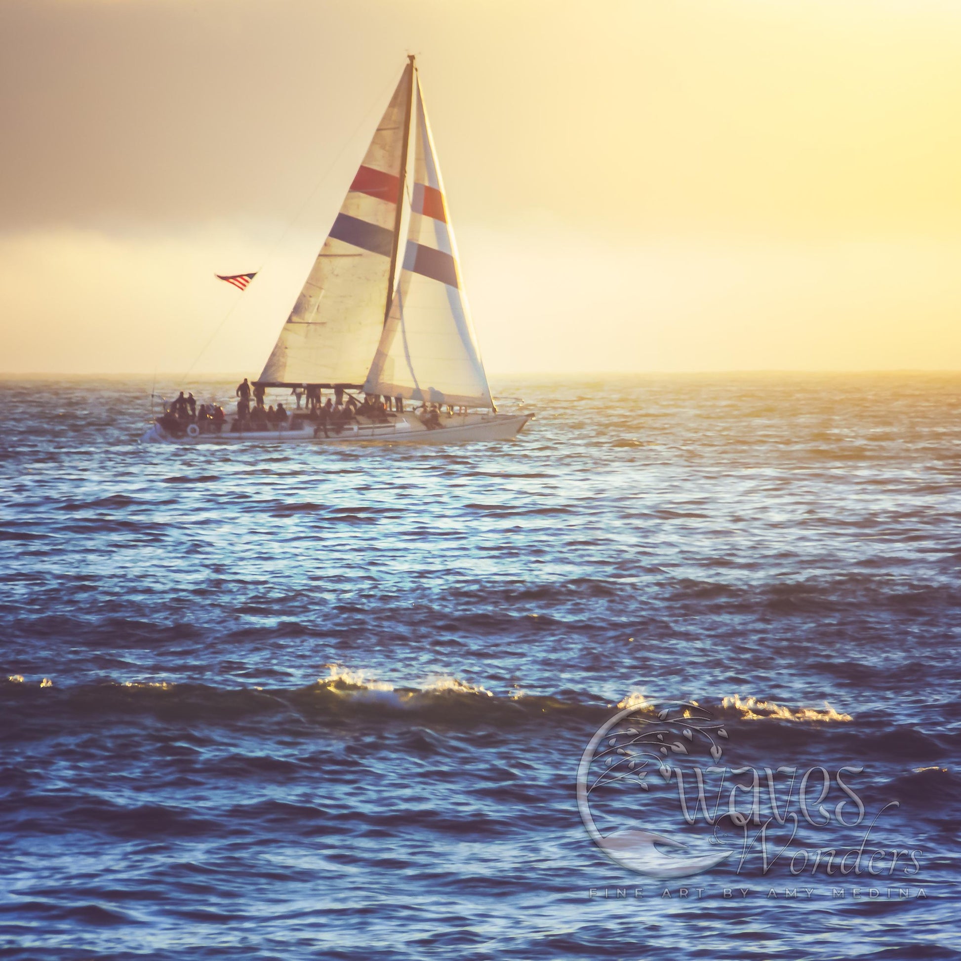 a sailboat sailing in the ocean at sunset