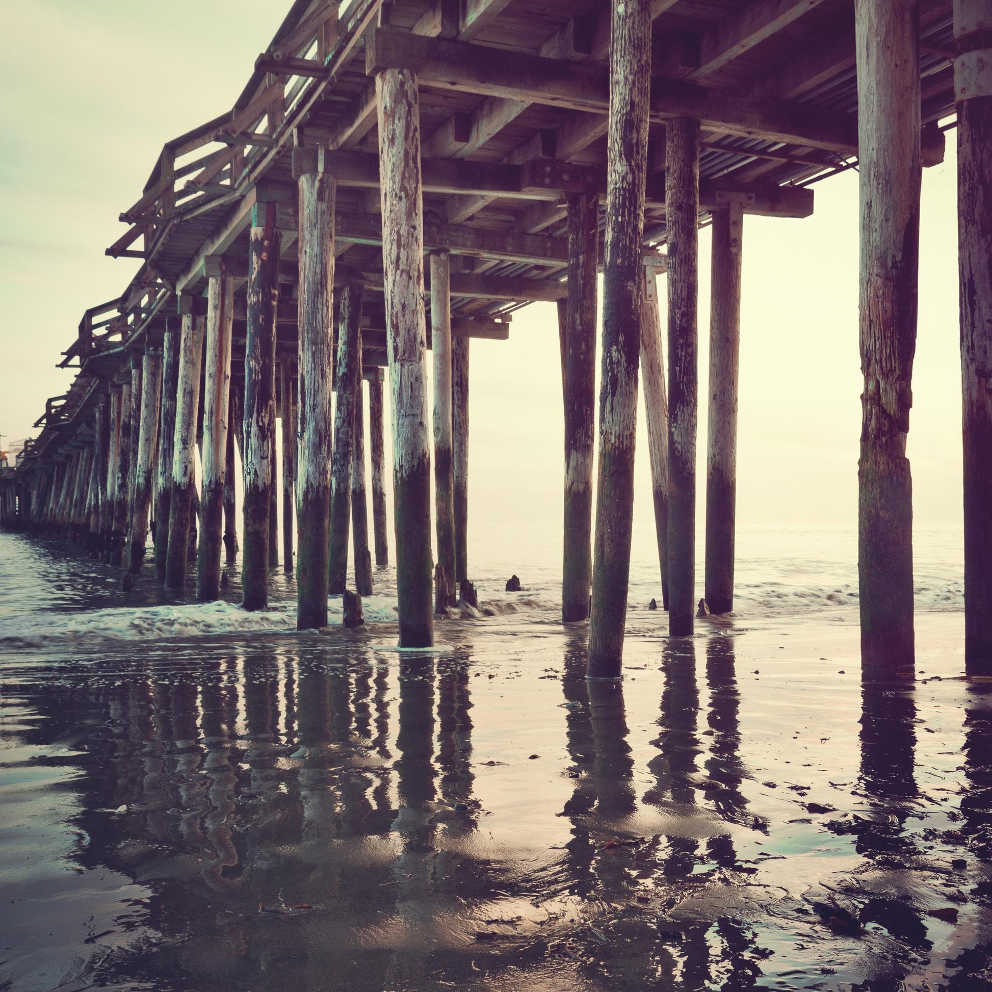 a wooden pier with water underneath it