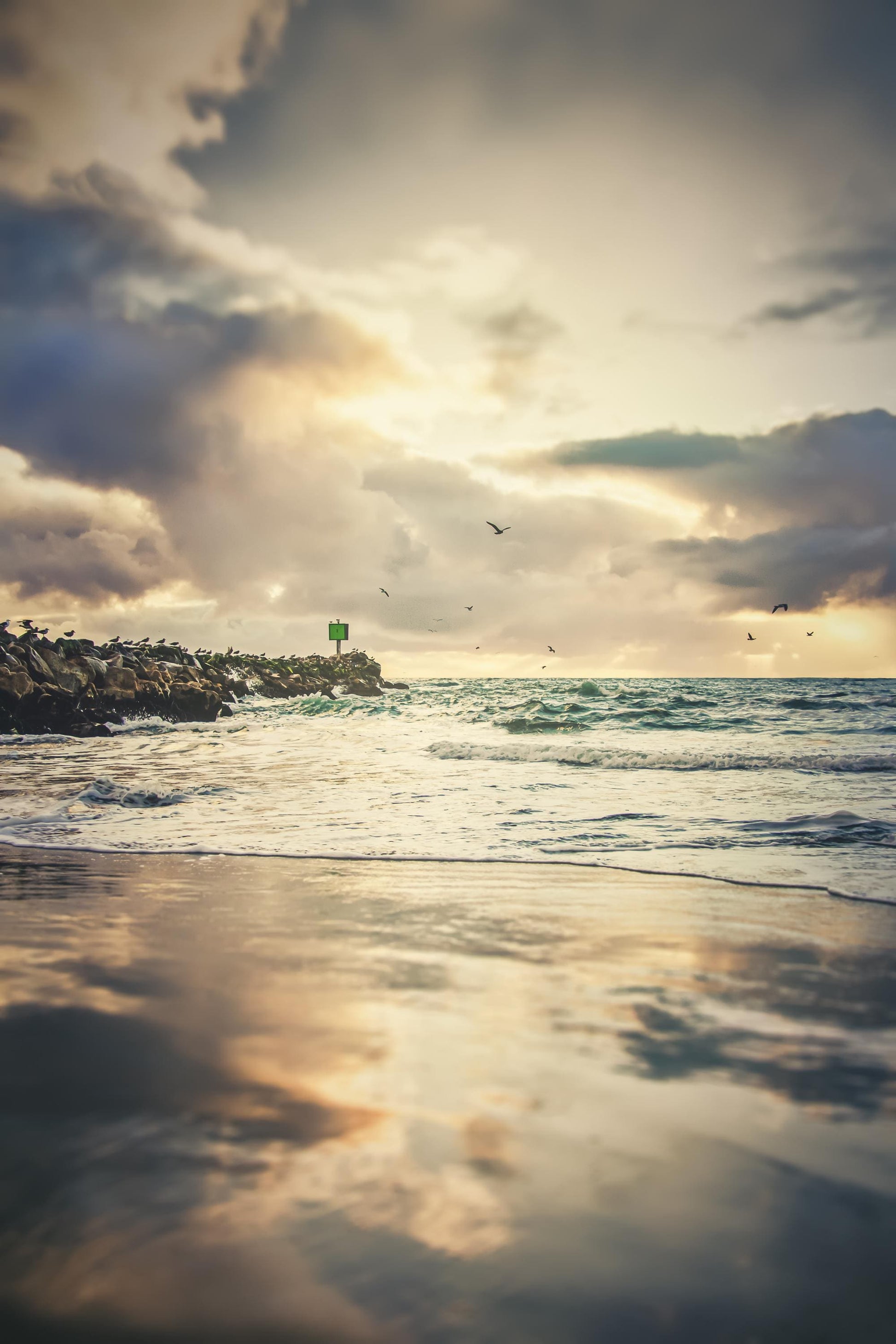 a view of the ocean with a lighthouse in the distance